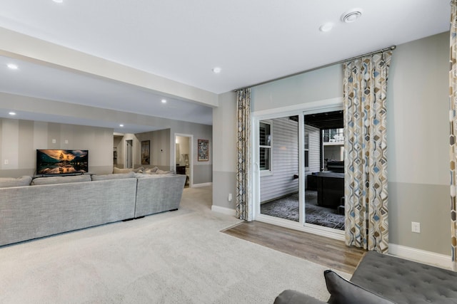 unfurnished living room featuring carpet floors, baseboards, and recessed lighting