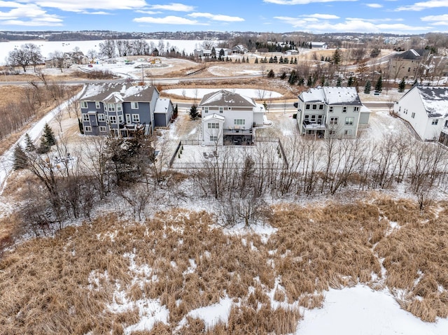 snowy aerial view featuring a residential view