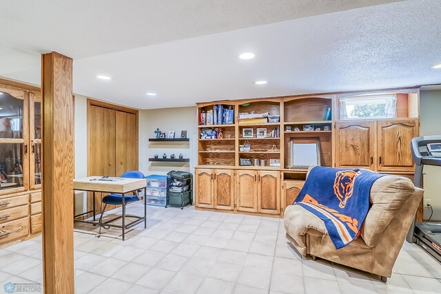 interior space with a textured ceiling and recessed lighting