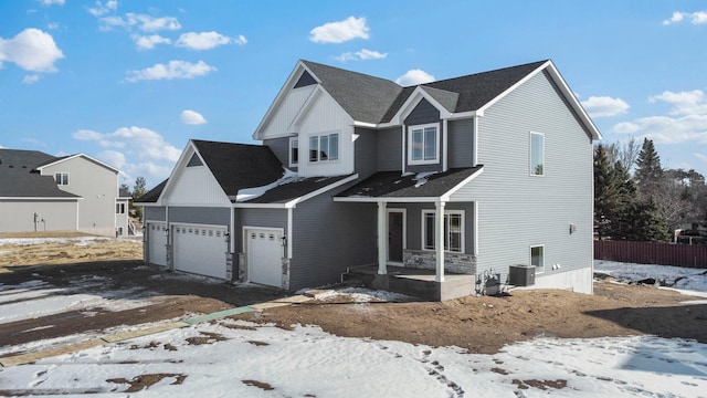 view of front of property with central air condition unit, covered porch, and an attached garage