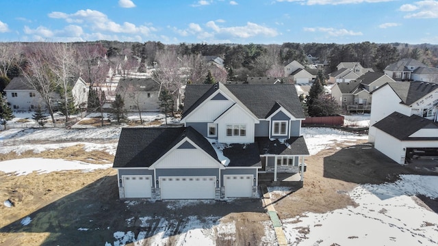 snowy aerial view featuring a residential view