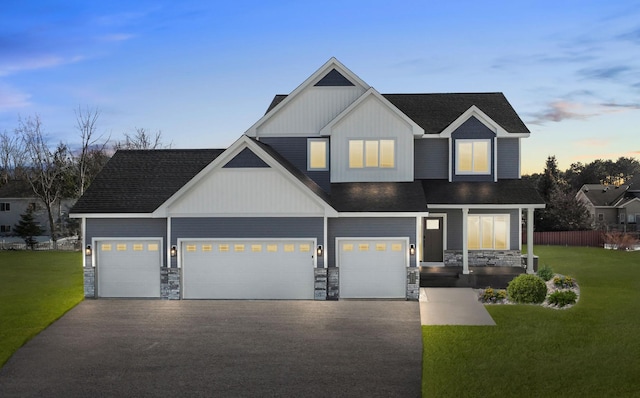 2080 151st Ave NW, Andover, MN 55304 - view of front of property featuring stone siding, asphalt driveway, a shingled roof, board and batten siding, and an attached garage