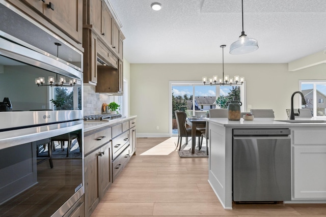 2080 151st Ave NW, Andover, MN 55304 - kitchen with appliances with stainless steel finishes, a sink, a chandelier, light countertops, and plenty of natural light