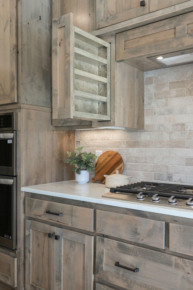 2080 151st Ave NW, Andover, MN 55304 - kitchen featuring light countertops, stainless steel appliances, tasteful backsplash, and wood walls