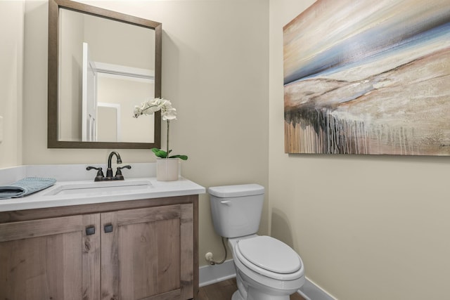2080 151st Ave NW, Andover, MN 55304 - bathroom featuring baseboards, toilet, vanity, and wood finished floors
