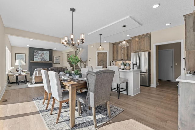 2080 151st Ave NW, Andover, MN 55304 - dining room with light wood-style floors, a chandelier, baseboards, stairs, and recessed lighting