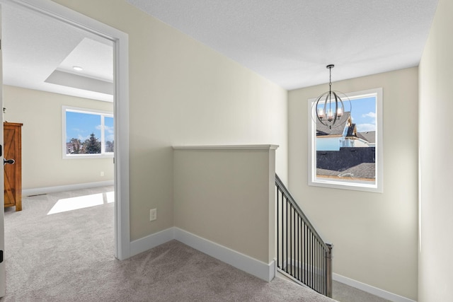 2080 151st Ave NW, Andover, MN 55304 - hall with a chandelier, an upstairs landing, carpet, and plenty of natural light