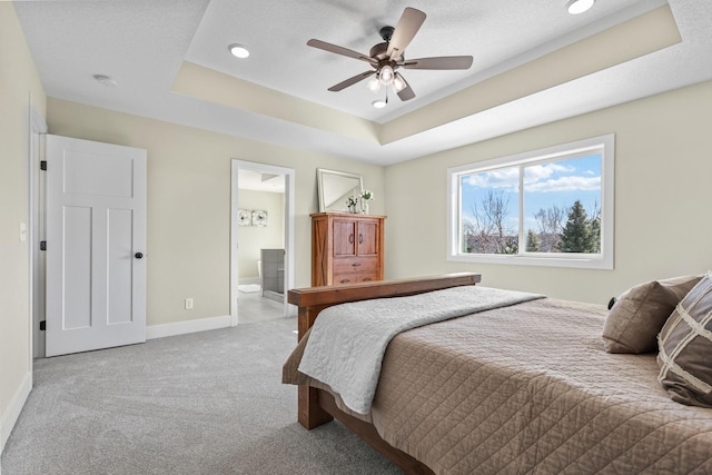 2080 151st Ave NW, Andover, MN 55304 - carpeted bedroom with a tray ceiling, baseboards, ensuite bath, ceiling fan, and recessed lighting