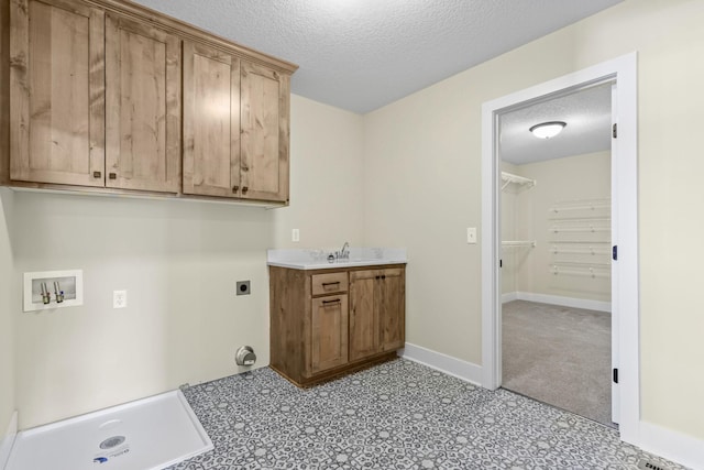 2080 151st Ave NW, Andover, MN 55304 - laundry room with hookup for an electric dryer, washer hookup, a textured ceiling, cabinet space, and baseboards