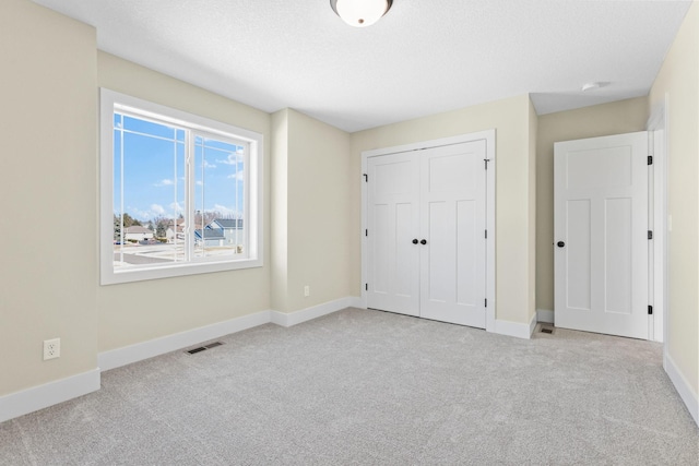 2080 151st Ave NW, Andover, MN 55304 - unfurnished bedroom with carpet flooring, baseboards, and a closet