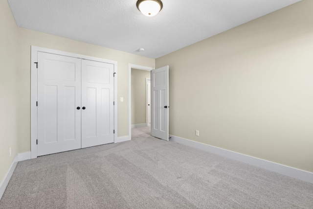 2080 151st Ave NW, Andover, MN 55304 - unfurnished bedroom featuring baseboards, carpet floors, a textured ceiling, and a closet