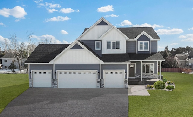 2080 151st Ave NW, Andover, MN 55304 - view of front of property with asphalt driveway, stone siding, a shingled roof, and a garage