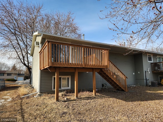 rear view of property with stairs, central air condition unit, and a wooden deck