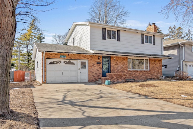 traditional home featuring fence, driveway, an attached garage, a chimney, and brick siding