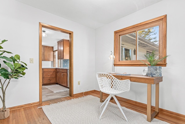 office featuring light wood-type flooring and baseboards