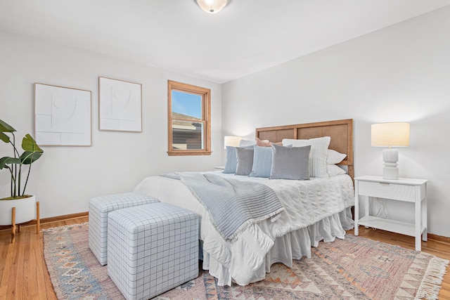 bedroom with baseboards and wood finished floors