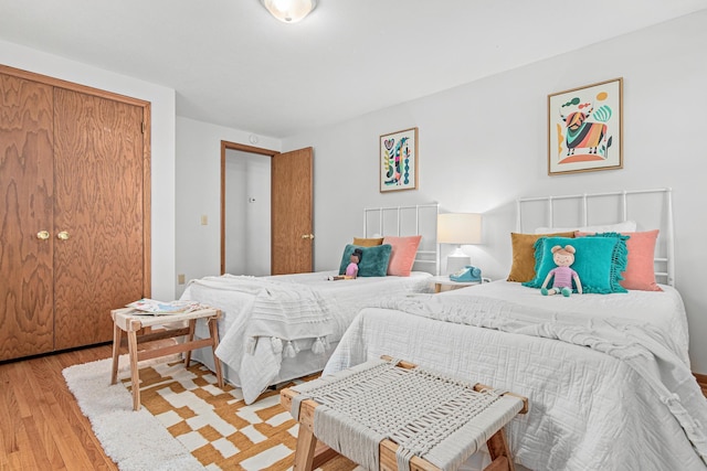 bedroom with a closet and light wood finished floors