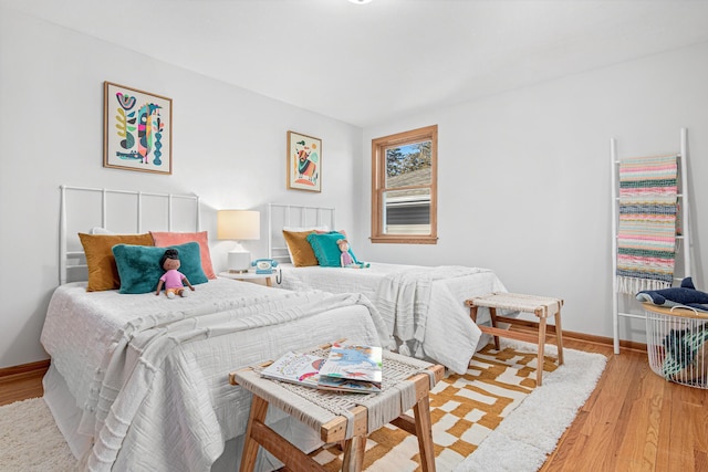 bedroom featuring baseboards and wood finished floors