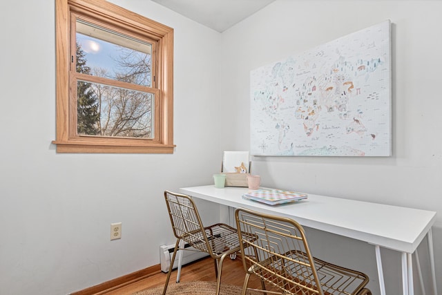 home office with baseboards and wood finished floors