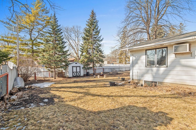 view of yard with a storage shed, a fenced backyard, and an outdoor structure