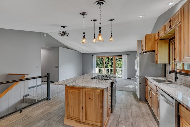 kitchen with stainless steel appliances, a kitchen island, a sink, vaulted ceiling, and light stone countertops