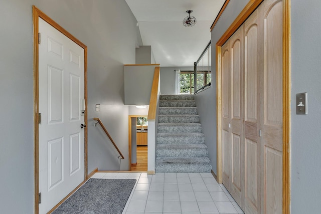 stairs featuring tile patterned flooring and baseboards