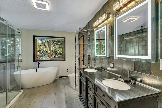 full bathroom featuring decorative backsplash, a freestanding tub, a sink, and a shower stall