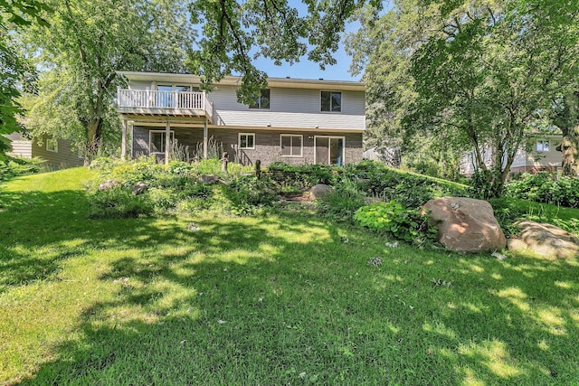 rear view of house featuring a yard