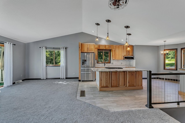 344 Riverside Ave S, Sartell, MN 56377 - kitchen with appliances with stainless steel finishes, lofted ceiling, a chandelier, backsplash, and a center island