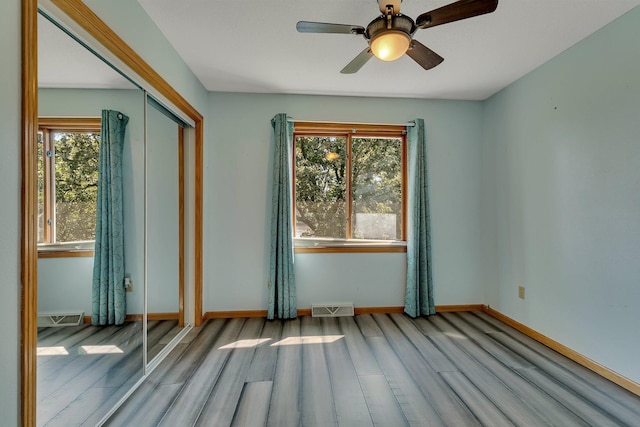 344 Riverside Ave S, Sartell, MN 56377 - spare room featuring wood finished floors, baseboards, and a ceiling fan