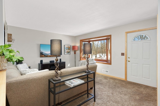 living area featuring baseboards, visible vents, and carpet flooring