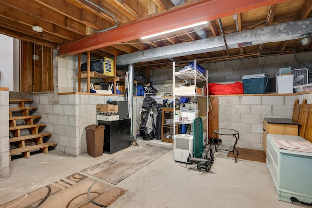 unfinished basement featuring stairway