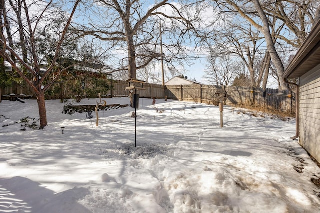 yard covered in snow featuring a fenced backyard