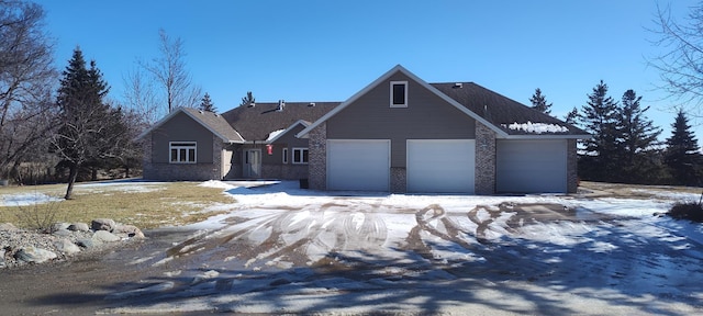 view of front facade with brick siding and an attached garage