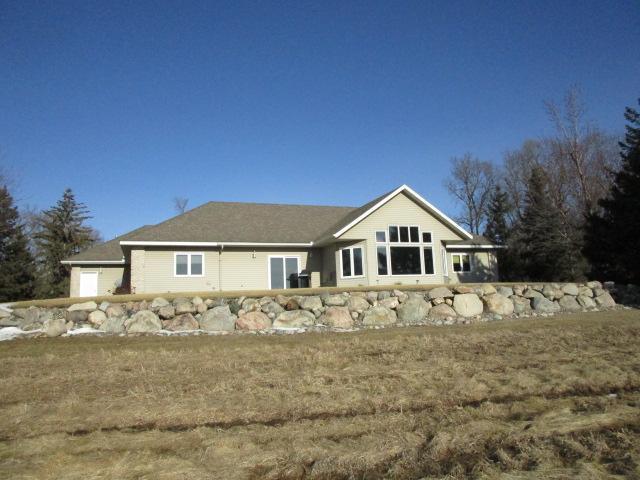 rear view of property with a garage