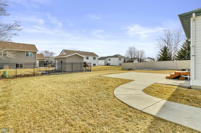 view of yard with a patio area, a residential view, and fence