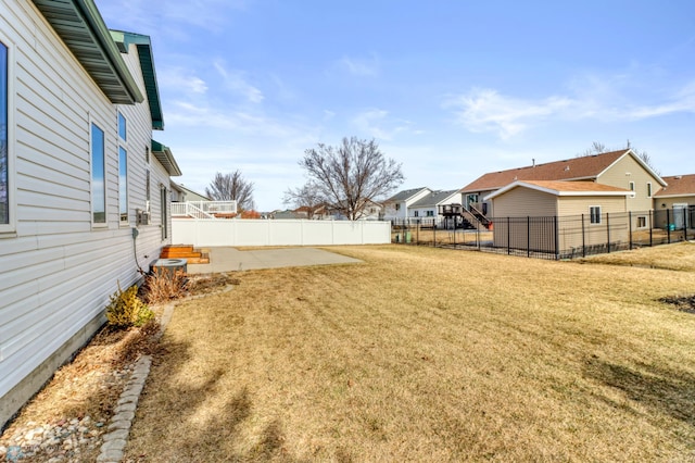 view of yard featuring central AC, a patio area, a residential view, and a fenced backyard