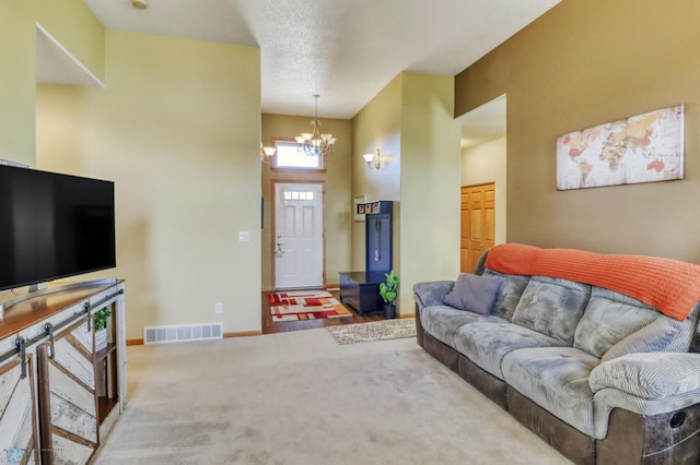 carpeted living area with an inviting chandelier, baseboards, and visible vents