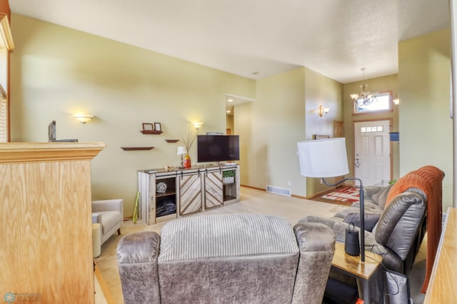 carpeted living room featuring a chandelier, visible vents, and baseboards