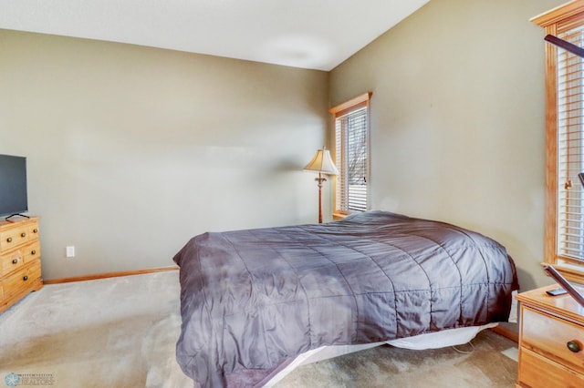 carpeted bedroom with baseboards