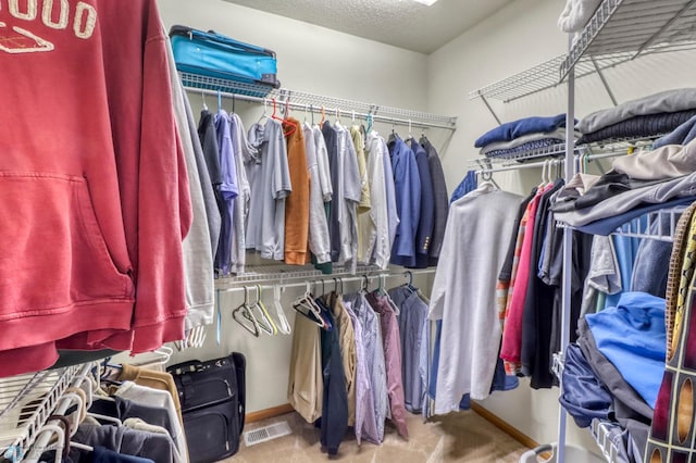 spacious closet with visible vents and carpet flooring