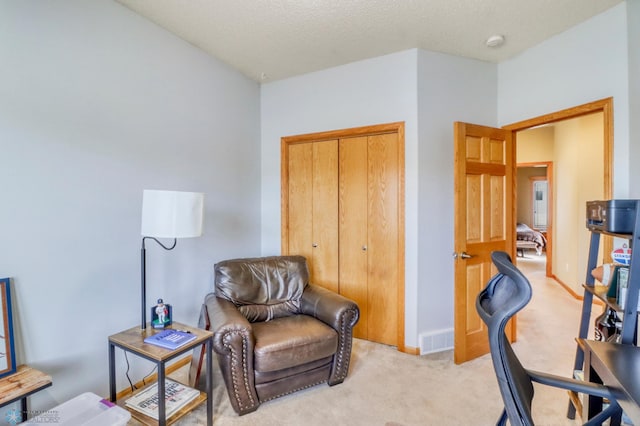 home office featuring visible vents, light colored carpet, and baseboards