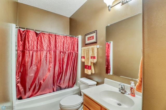 bathroom with vanity, shower / bath combination with curtain, toilet, and a textured ceiling