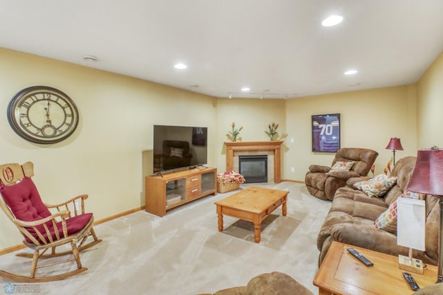 carpeted living room with a tiled fireplace, recessed lighting, and baseboards