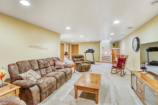 living room featuring recessed lighting, light carpet, and stairs