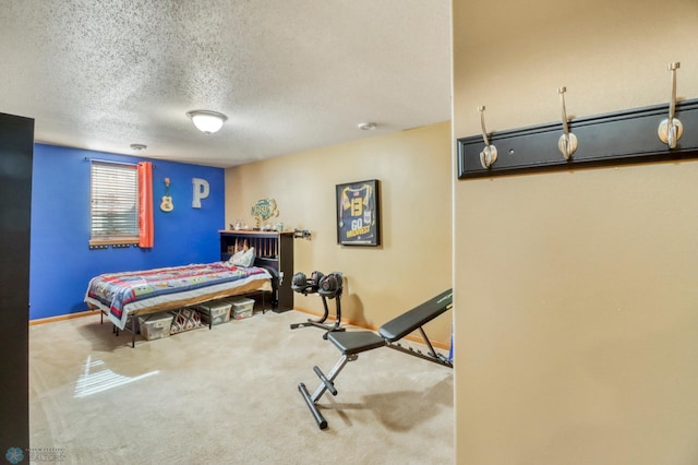 bedroom featuring baseboards, a textured ceiling, and carpet