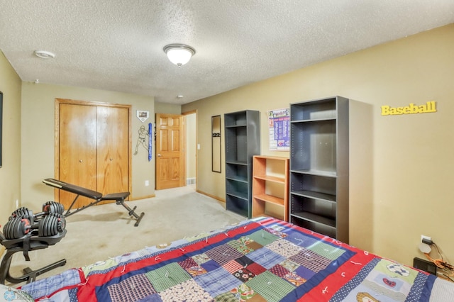 bedroom featuring a closet, carpet floors, a textured ceiling, and baseboards