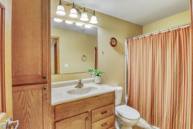 full bathroom with a textured ceiling, toilet, vanity, and a shower with curtain