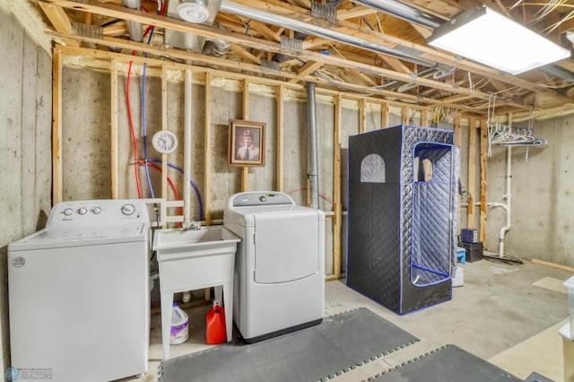 unfinished basement featuring a sink and independent washer and dryer