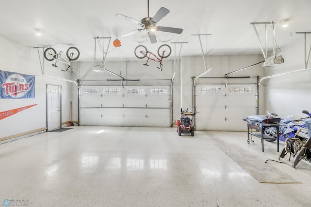 garage with a ceiling fan and a garage door opener